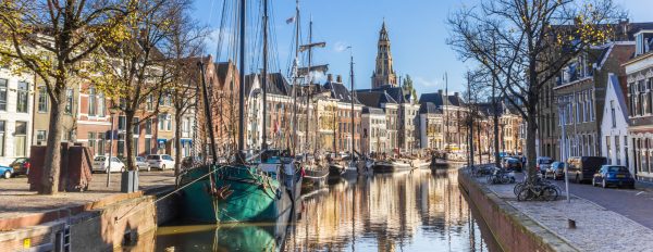 Panorama of historic ships and warehouses in the center of Groningen, Netherlands